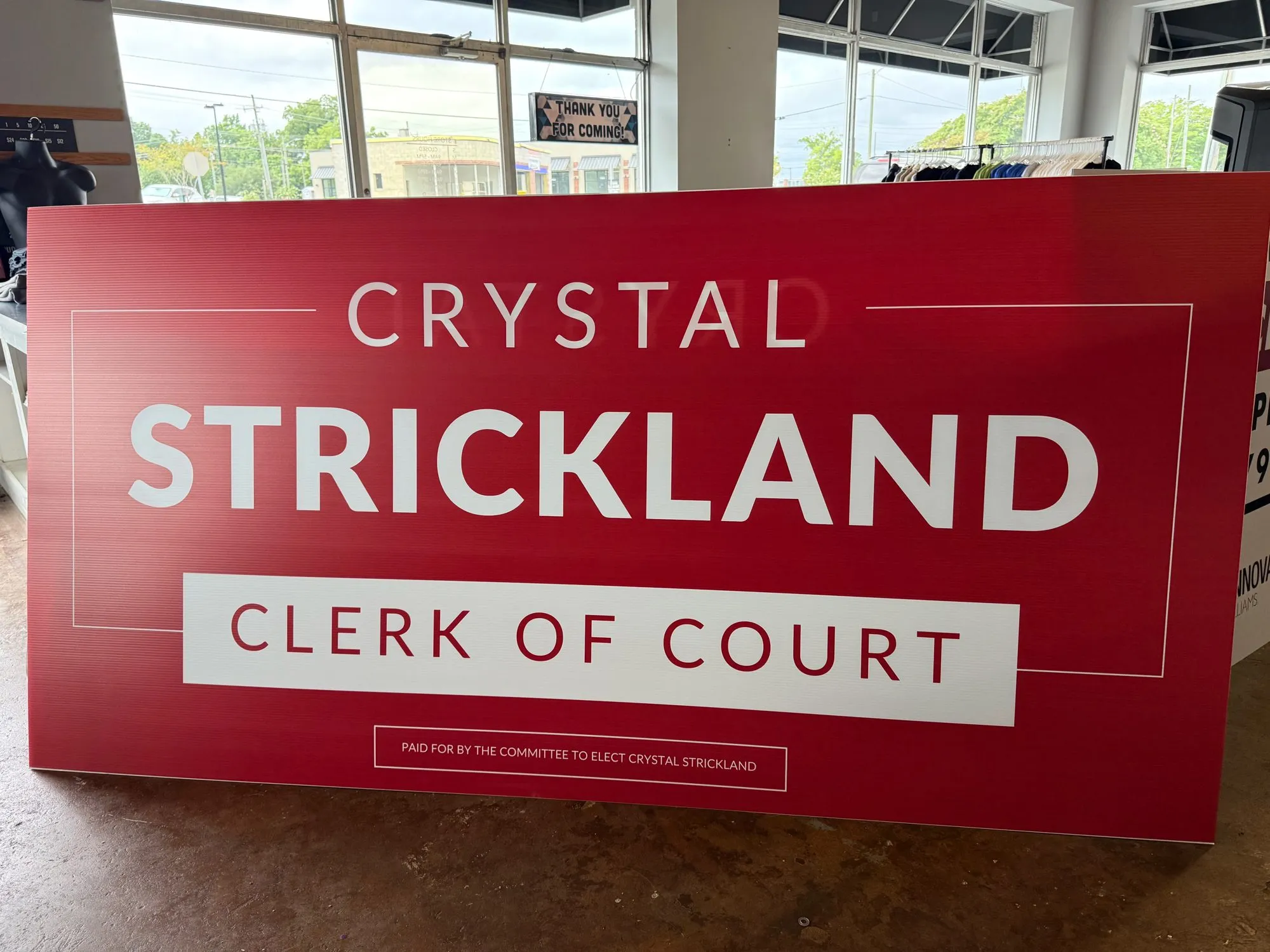 Red Crystal Strickland Clerk of Court sign panel in the shop
