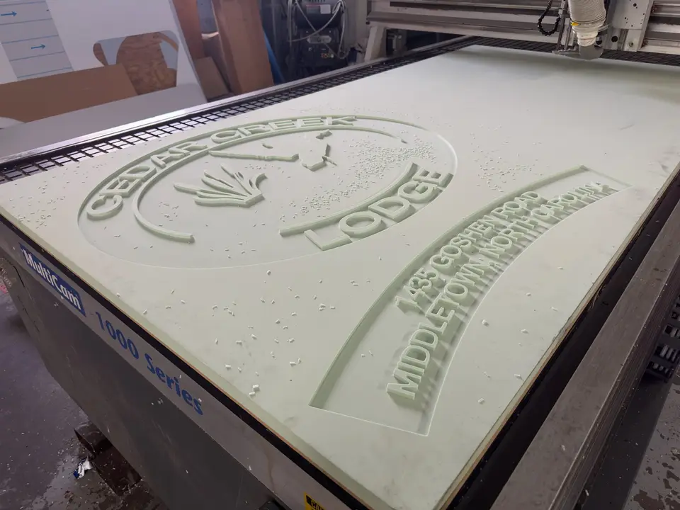 Cedar Creek Lodge relief sign on a CNC router table