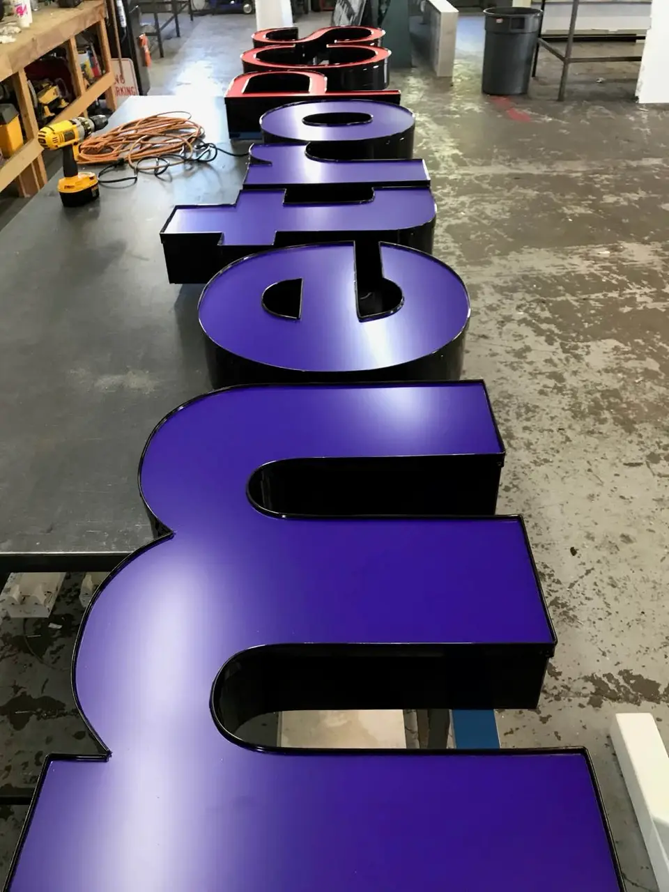 Purple dimensional letters arranged on a shop table