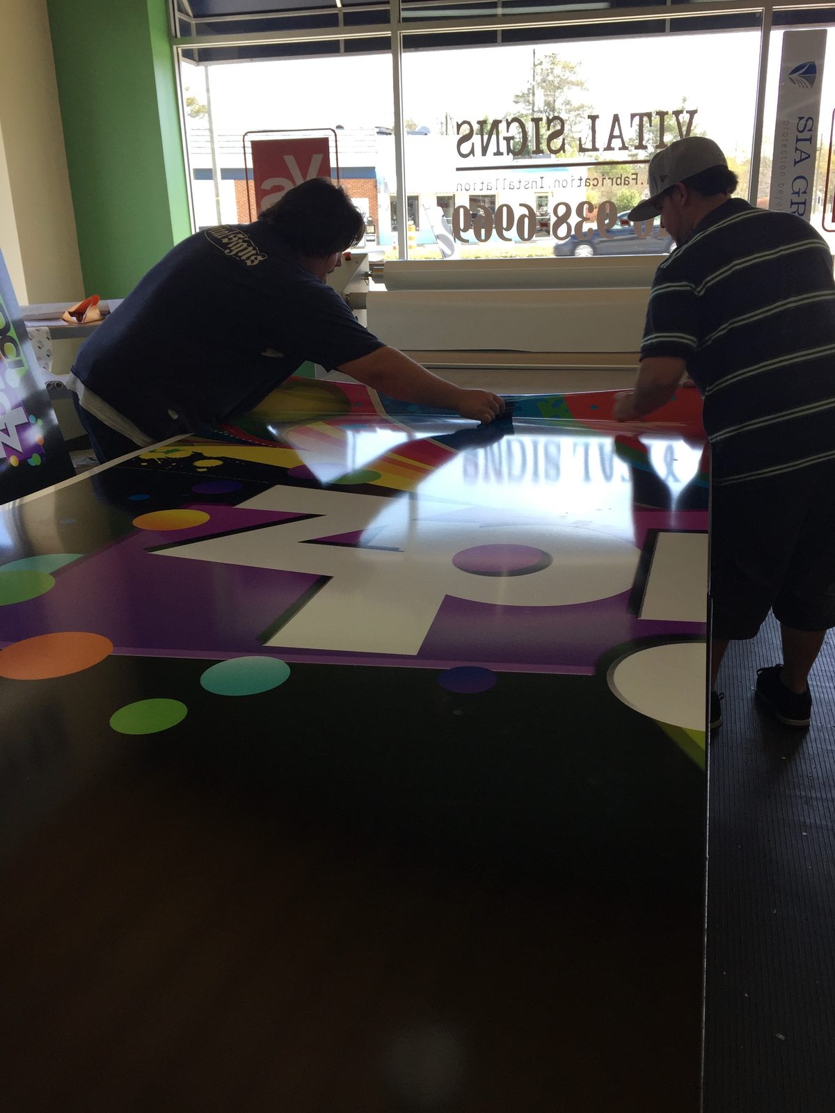 Team producing colorful sign graphics